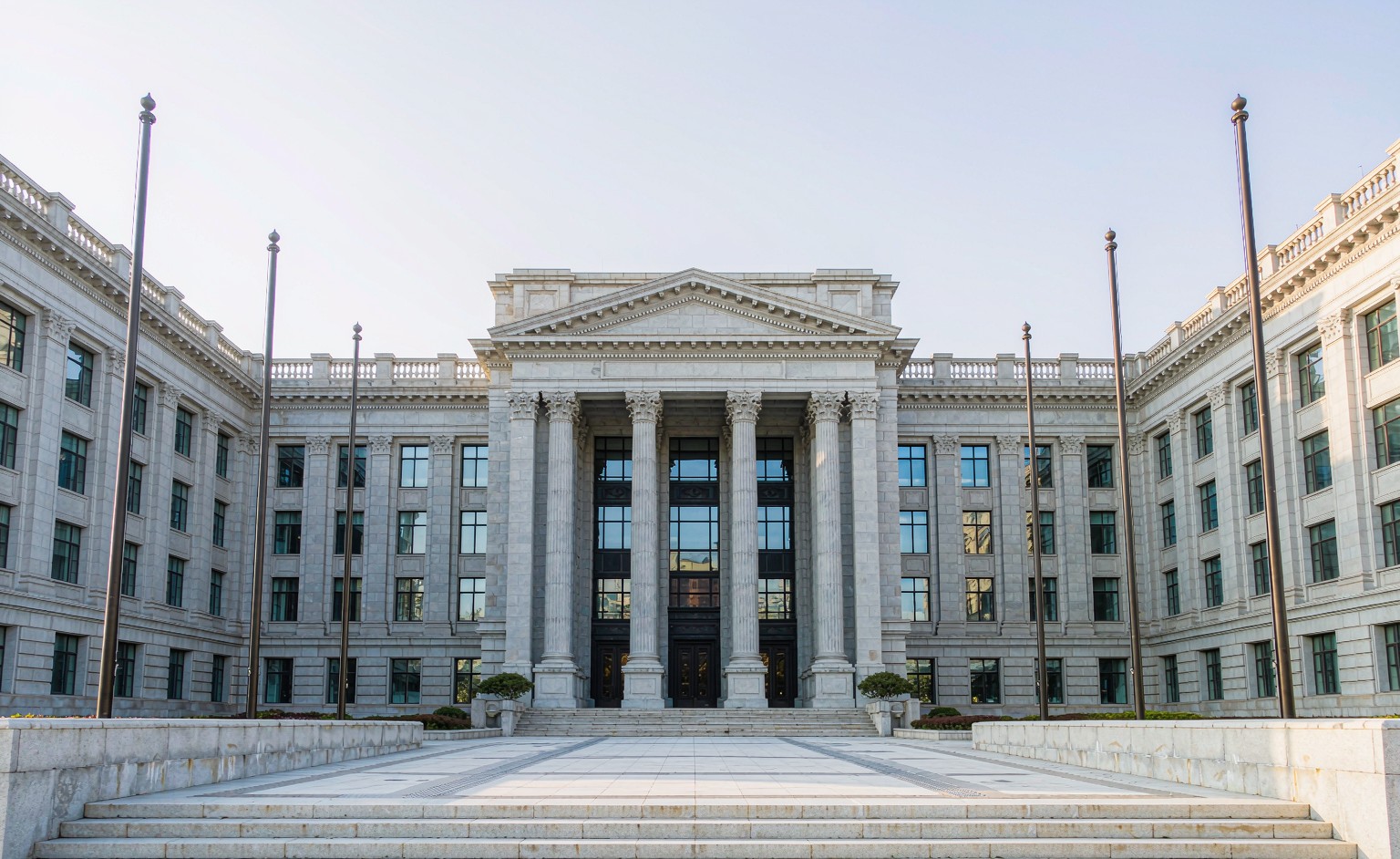 Government archive building with columned facade and flagpoles