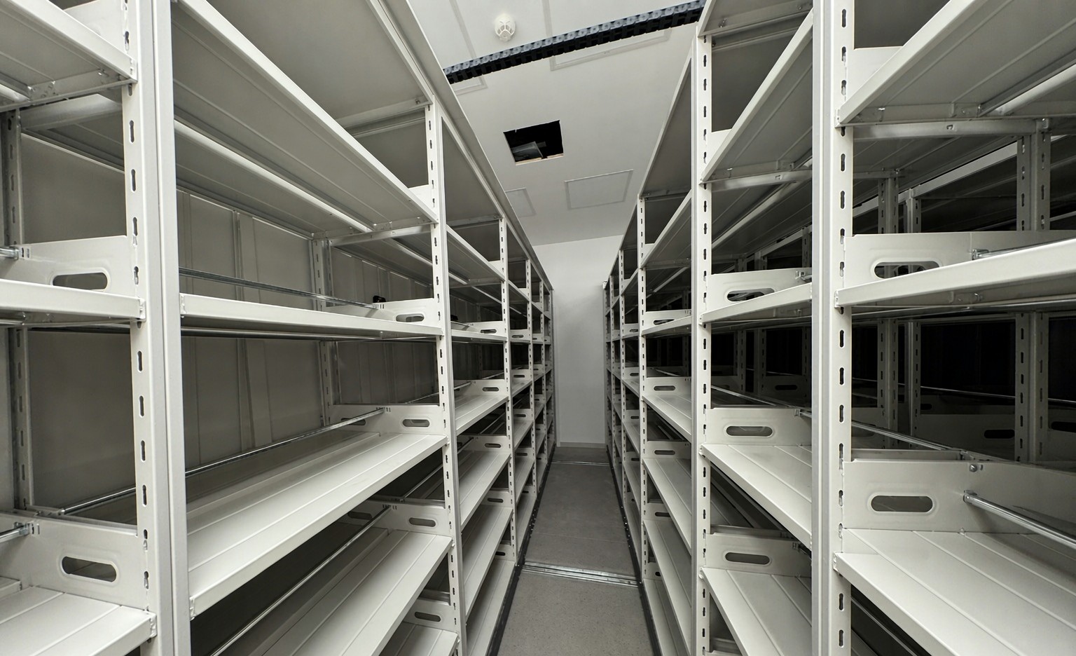Wide aisle of electric compact shelving in a public record center
