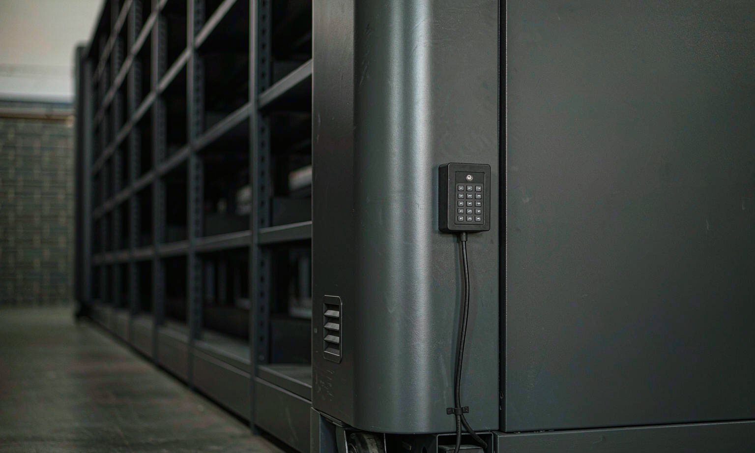 Compact shelving end panel with electronic keypad access control