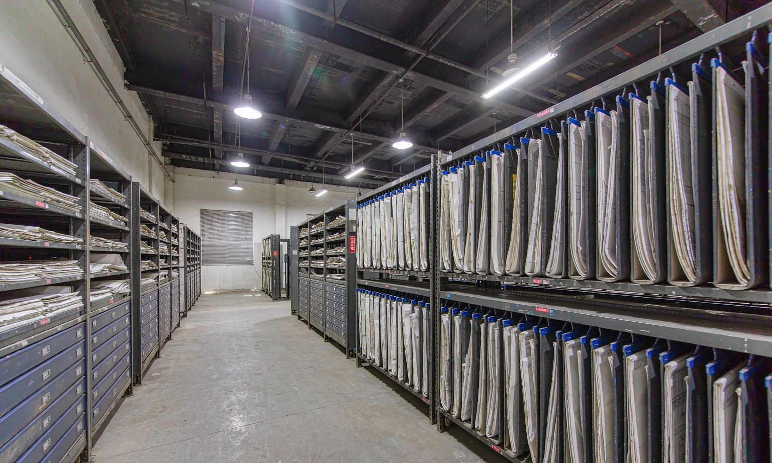 Industrial technical archive with mobile compact shelving storing engineering drawings
