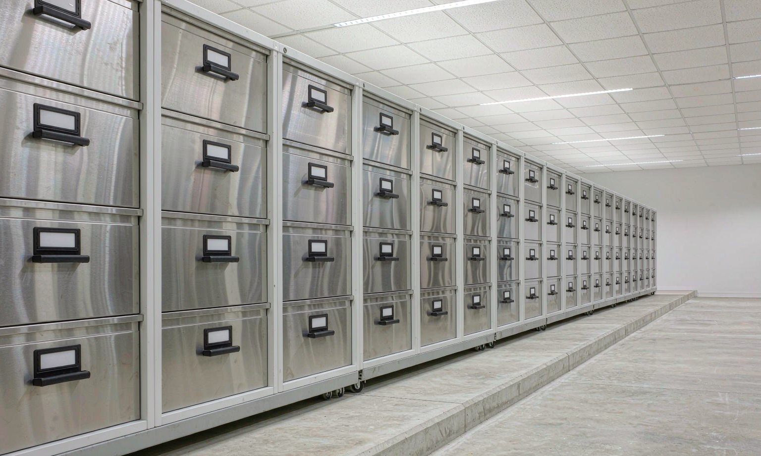 Long row of flat-file plan chests on a mobile compact shelving base