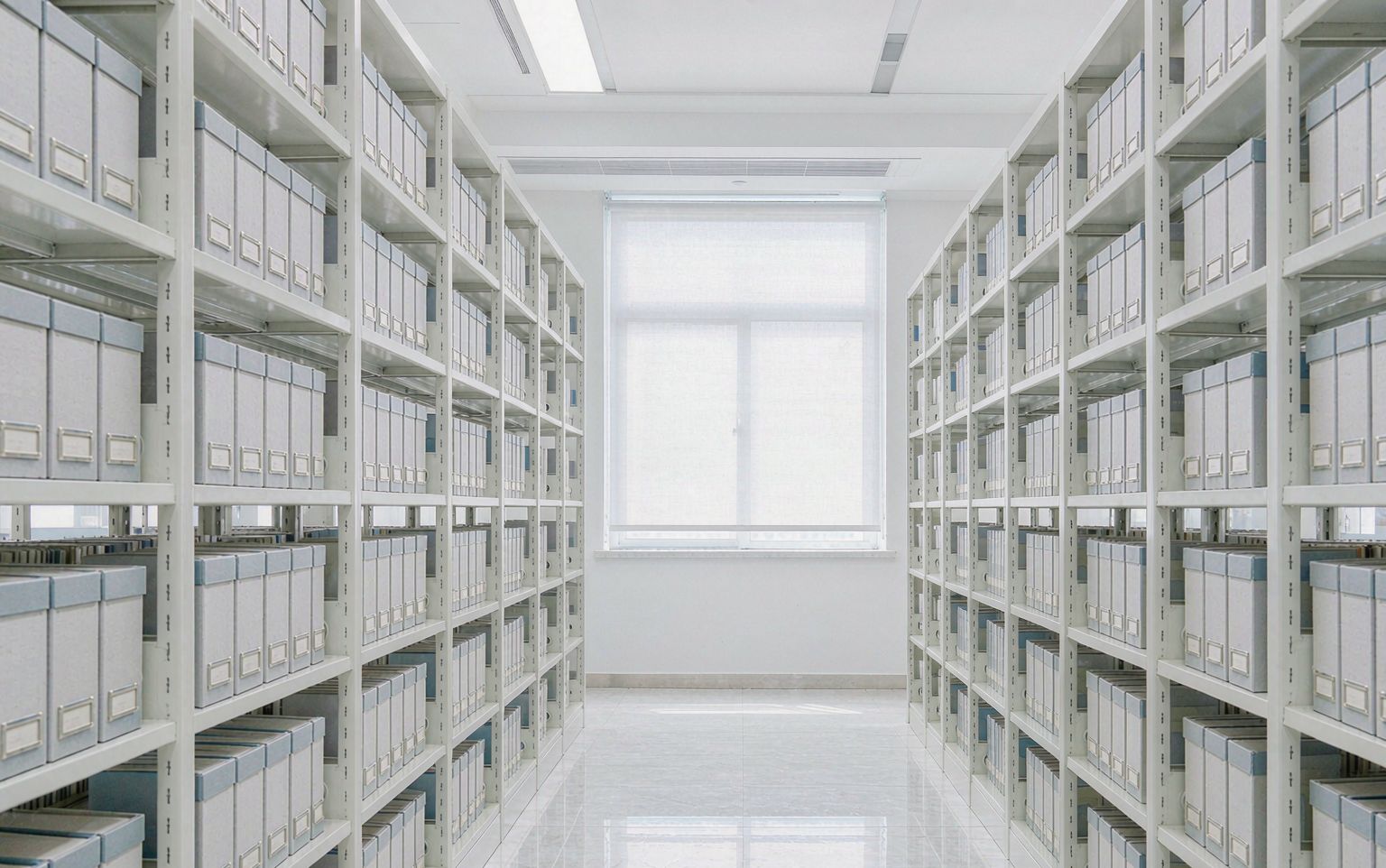 Bright institutional archive aisle with archive boxes on mobile shelving